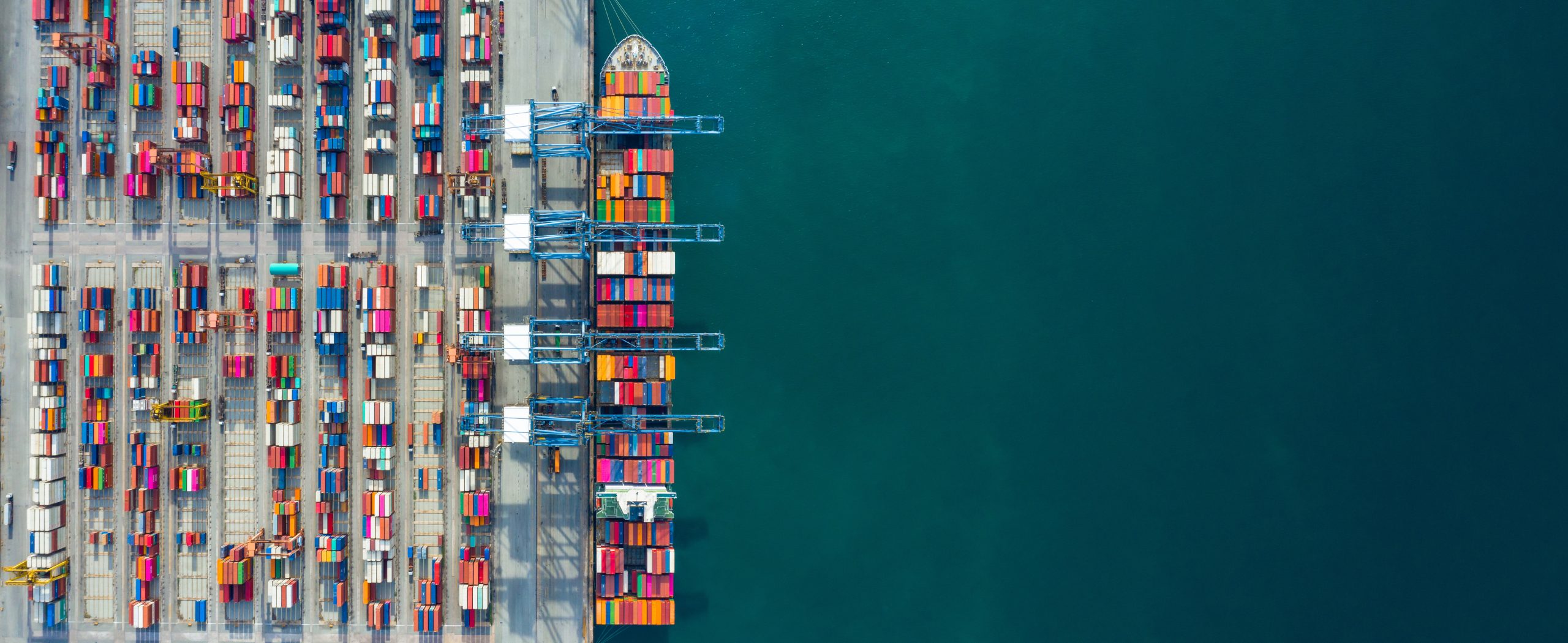 Aerial view container ship in port at container terminal port, Ship of container ship stand in terminal port on loading, unloading container, Commercial cargo ship in sea port.