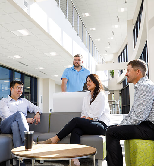 KBX employees working around table