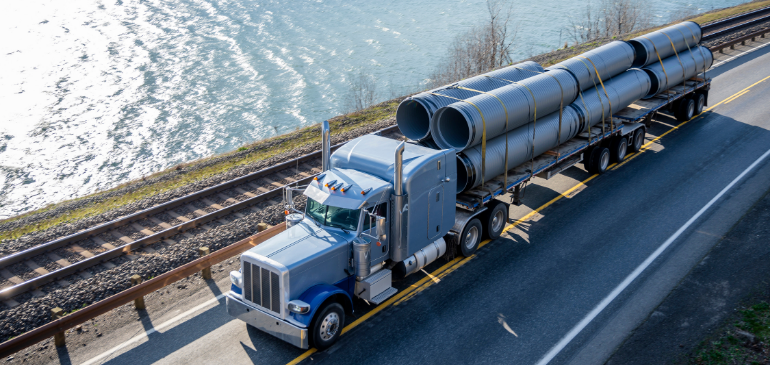 Trucking hauling equipment on highway
