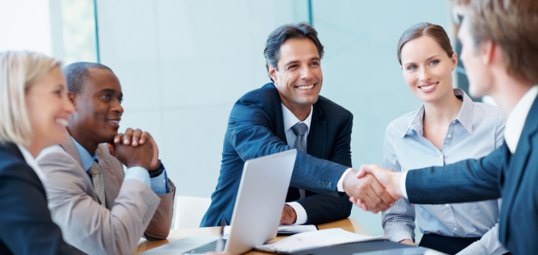 Executives giving handshake